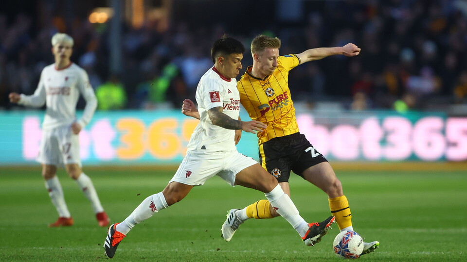 Lisandro Martínez of Manchester United and Harry Charsley of Newport County in action